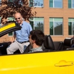 Man getting into a yellow car