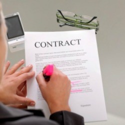A woman signing a contract.