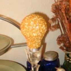 A recycled light bulb covered in popcorn.