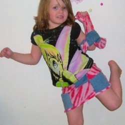 Young girl wearing a patchwork skirt.