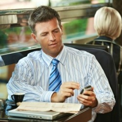 Man Using Smartphone in Coffee Shop