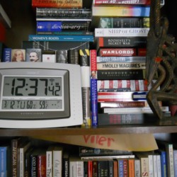 Bookshelf piled with books.