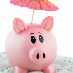A pink piggy bank on the beach.