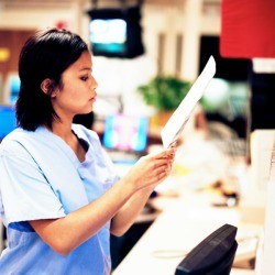 A nurse reading a chart.