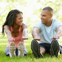 Couple Stretching on Grass