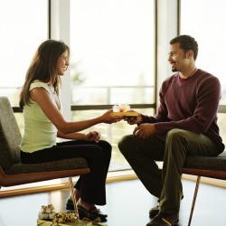 Woman giving her boyfriend a gift.