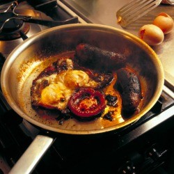 Breakfast burnt and stuck to the bottom of a pan.