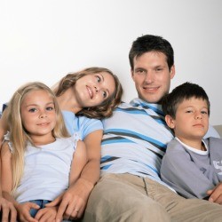 A family sitting and watching TV.