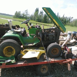 Riding mower on trailer.