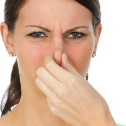 A woman holding her nose.