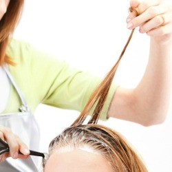 A woman having her hair dyed.