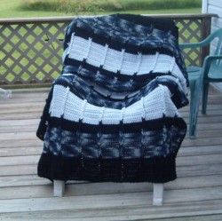 Afghan displayed on deck chair.