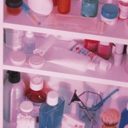 An medicine cabinet filled with bottles and other toiletries.