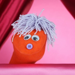 A sock puppet with a button for a nose.