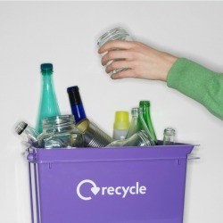 Glass Jar Being Put in Recycling Bin