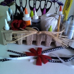 Craft supplies in pasteboard packing material.
