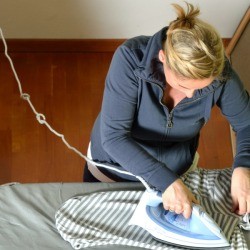 A woman ironing clothing.