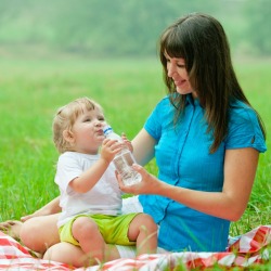 Using a plastic tablecloth as a picnic blanket.