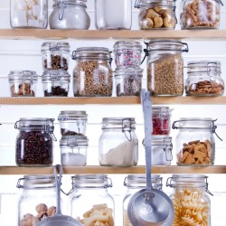 Stored food in a jars in a pantry.