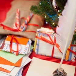 bundles of Christmas letters with quill pen and ink pot