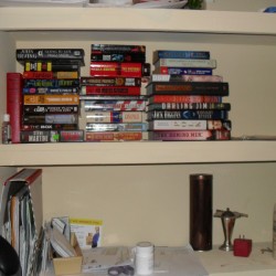 upper shelves with books lying on their side