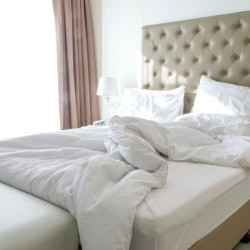 messy bed with white comforter 