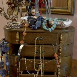 jewelry box with drawers overflowing with jewelry