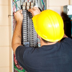 electrician working on breaker box