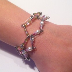 Safety pin bracelet being worn on wrist.
