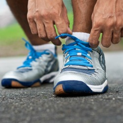 man tying sneaker