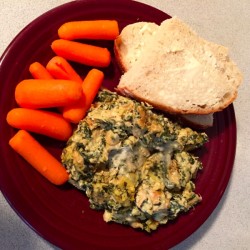 A dish of crockpot spinach artichoke chicken. 
