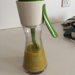 A container filled with homemade vinaigrette.