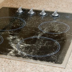 Glass top stove covered in white powder 