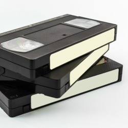 Three blank VHS tapes stacked against a white surface