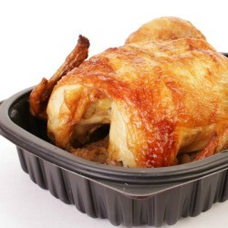 Rotisserie chicken in a plastic to go box