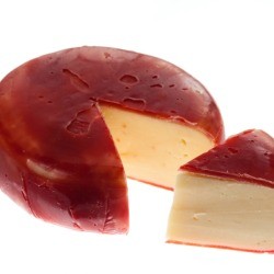 Gouda cheese wheel with wedge 