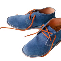 Pair of blue suede shoes on white background
