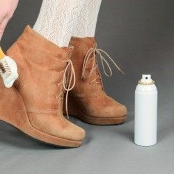 Woman cleaning suede wedge booties