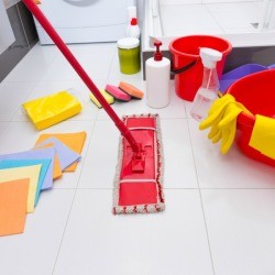 Floor cleaning tools like mop, rags, etc. displayed on vinyl tile floor