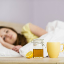 A sick woman with honey cold treatments.