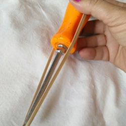 A rubber band over a screwdriver.