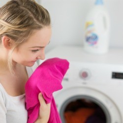A woman smelling laundry.