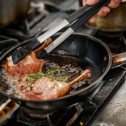 Pan frying duck legs.