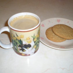 A pumpkin spice latte with some cookies.