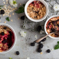Ramekins with baked fruit crisps, ready to eat.