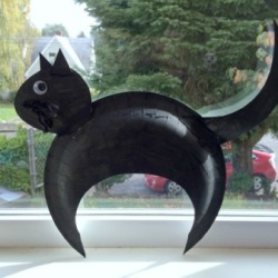 A black cat made with paper plates. 