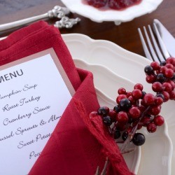 A place setting for Thanksgiving, including a menu.