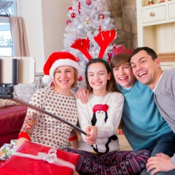 A family taking a selfie with a new selfie stick at Christmas.
