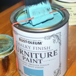 An elastic band stretched across the paint can opening.