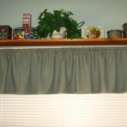 A space saving display shelf over a window.
